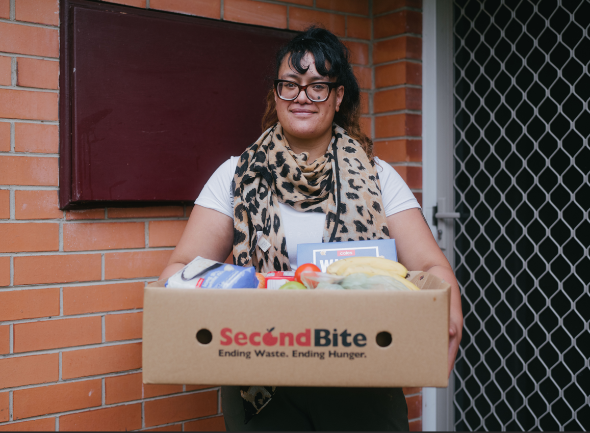 A picture of a women holding a box of food